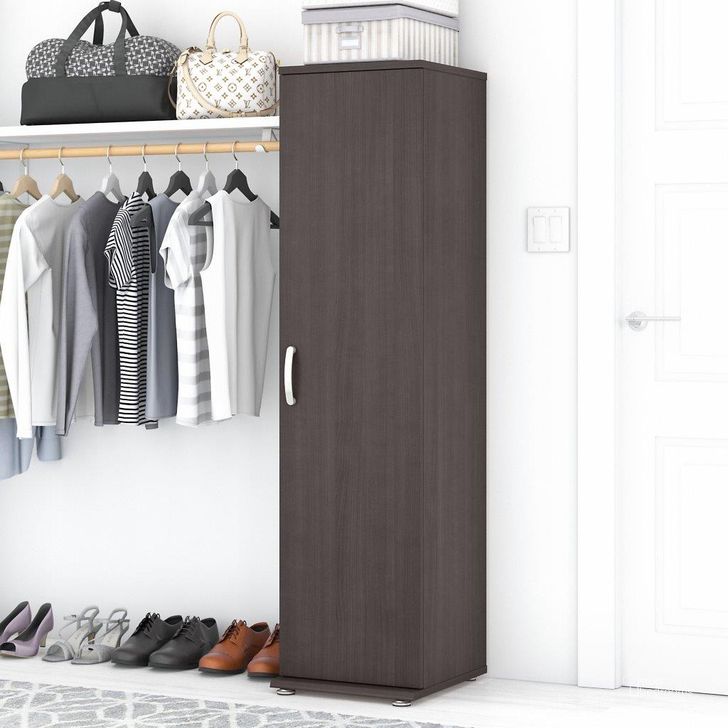 The appearance of Bush Business Furniture Universal Narrow Clothing Storage Cabinet with Door and Shelves in Storm Gray designed by Bush Furniture in the modern / contemporary interior design. This dark gray piece of furniture  was selected by 1StopBedrooms from Closet Storage Collection to add a touch of cosiness and style into your home. Sku: CLS116SG-Z. Material: Wood. Product Type: Storage Cabinet. Image1