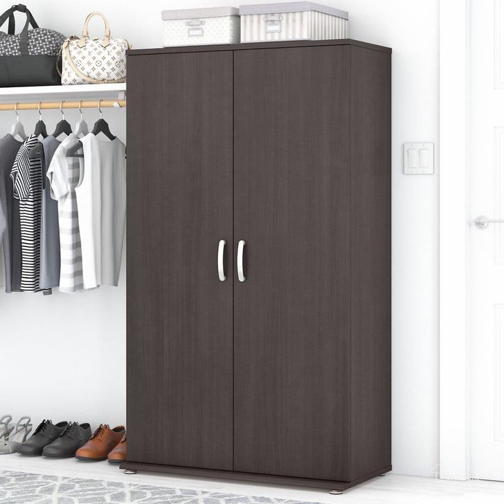 The appearance of Bush Business Furniture Universal Tall Clothing Storage Cabinet with Doors and Shelves in Storm Gray designed by Bush Furniture in the modern / contemporary interior design. This dark gray piece of furniture  was selected by 1StopBedrooms from Closet Storage Collection to add a touch of cosiness and style into your home. Sku: CLS136SG-Z. Material: Wood. Product Type: Storage Cabinet. Image1