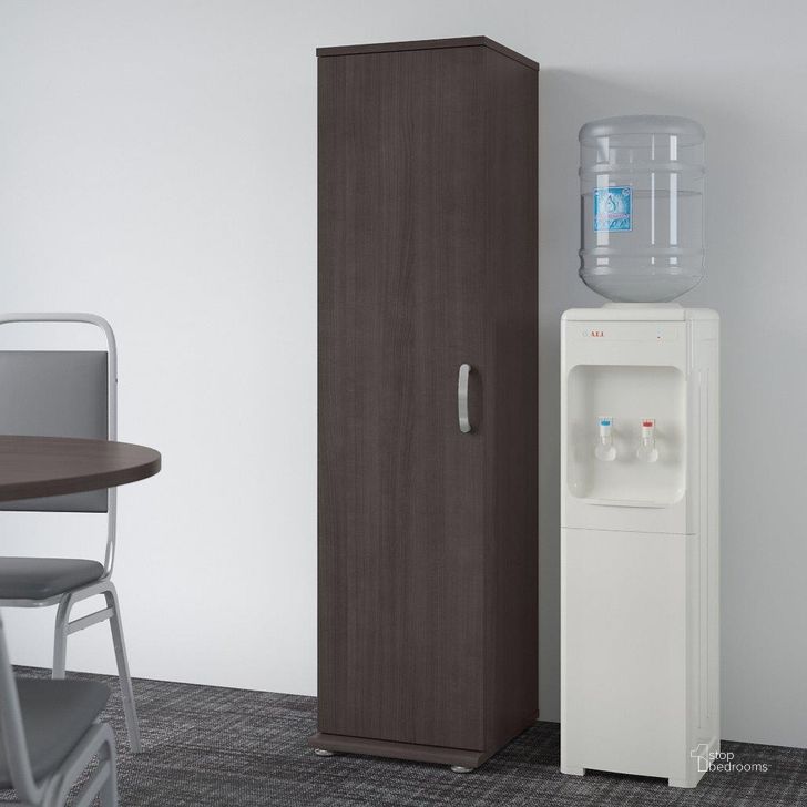 The appearance of Bush Business Furniture Universal Tall Narrow Storage Cabinet With Door And Shelves In Storm Gray designed by Bush Furniture in the modern / contemporary interior design. This brown piece of furniture  was selected by 1StopBedrooms from Universal Collection to add a touch of cosiness and style into your home. Sku: UNS116SG. Product Type: Storage Cabinet. Image1