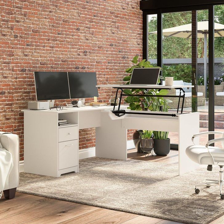 The appearance of Bush Furniture Cabot 60W 3 Position Sit To Stand L Shaped Desk in White designed by Bush Furniture in the modern / contemporary interior design. This white piece of furniture  was selected by 1StopBedrooms from Cabot Collection to add a touch of cosiness and style into your home. Sku: CAB043WHN. Material: Wood. Product Type: Desk. Image1