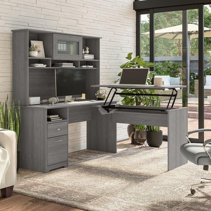 The appearance of Bush Furniture Cabot 60W 3 Position Sit To Stand L Shaped Desk with Hutch in Modern Gray designed by Bush Furniture in the modern / contemporary interior design. This gray piece of furniture  was selected by 1StopBedrooms from Cabot Collection to add a touch of cosiness and style into your home. Sku: CAB045MG. Material: Wood. Product Type: Desk & Hutch. Image1