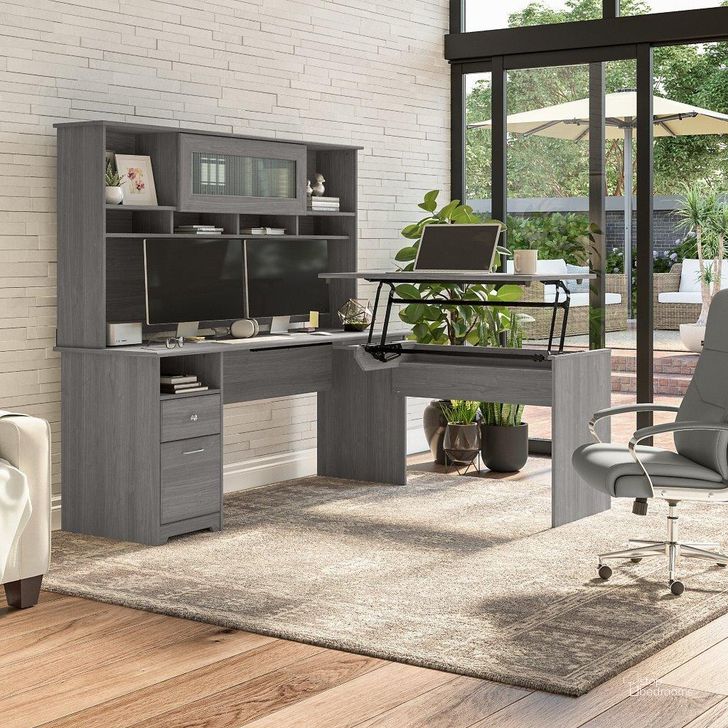 The appearance of Bush Furniture Cabot 72W 3 Position Sit To Stand L Shaped Desk with Hutch in Modern Gray designed by Bush Furniture in the modern / contemporary interior design. This gray piece of furniture  was selected by 1StopBedrooms from Cabot Collection to add a touch of cosiness and style into your home. Sku: CAB052MG. Material: Wood. Product Type: Desk & Hutch. Image1
