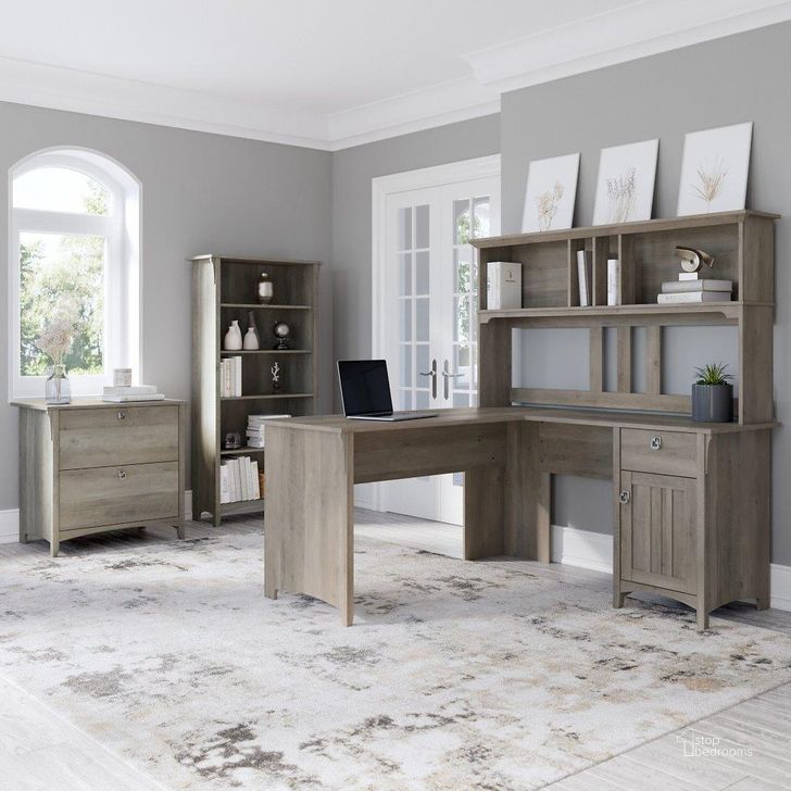 The appearance of Bush Furniture Salinas 60W L Shaped Desk with Hutch, Lateral File Cabinet and 5 Shelf Bookcase in Driftwood Gray designed by Bush Furniture in the country / farmhouse interior design. This gray piece of furniture  was selected by 1StopBedrooms from Salinas Collection to add a touch of cosiness and style into your home. Sku: SAL007DG. Product Type: Desk & Hutch. Image1