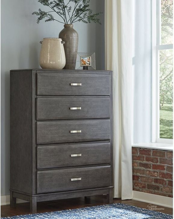 The appearance of Caitbrook Gray Five Drawer Chest designed by Signature Design by Ashley in the modern / contemporary interior design. This gray piece of furniture  was selected by 1StopBedrooms from Caitbrook Collection to add a touch of cosiness and style into your home. Sku: B476-46. Material: Wood. Product Type: Chest. Image1