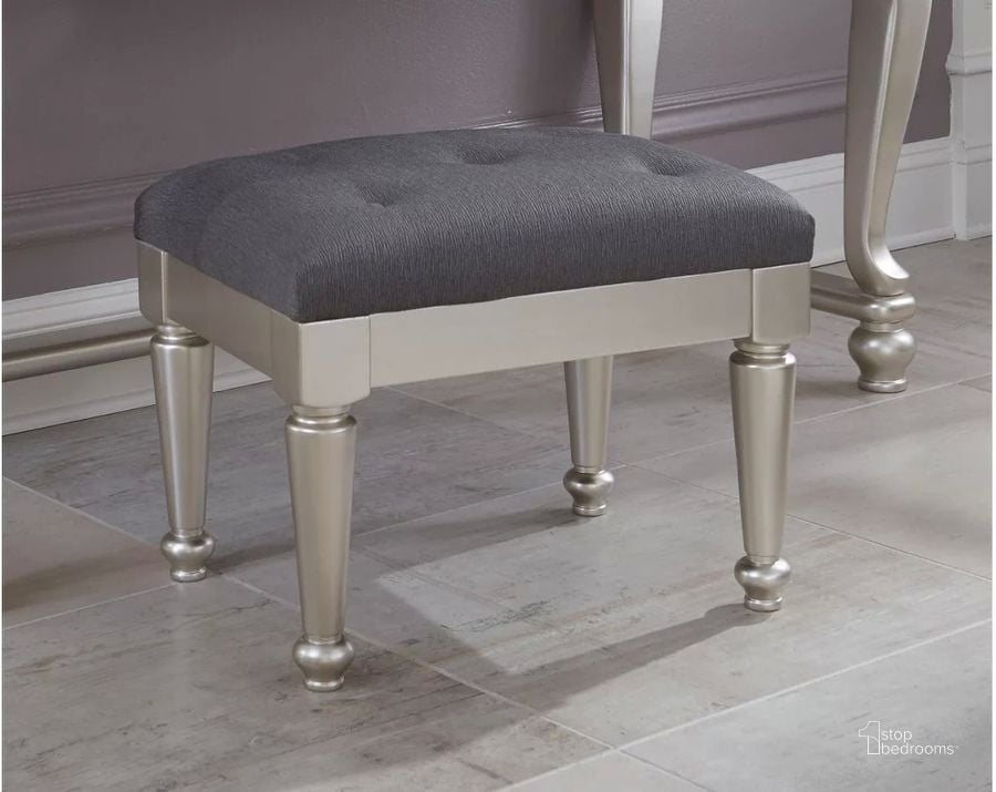 The appearance of Coralayne Silver Upholstered Stool designed by Signature Design by Ashley in the modern / contemporary interior design. This silver piece of furniture  was selected by 1StopBedrooms from Coralayne Collection to add a touch of cosiness and style into your home. Sku: B650-01. Material: Fabric. Product Type: Vanity Stool. Image1