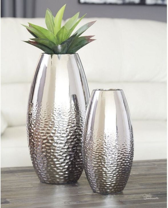 The appearance of Dinesh Silver Vase Set of 2 designed by Signature Design by Ashley in the modern / contemporary interior design. This silver piece of furniture  was selected by 1StopBedrooms from Dinesh Collection to add a touch of cosiness and style into your home. Sku: A2000355. Material: Ceramic. Product Type: Vase. Image1