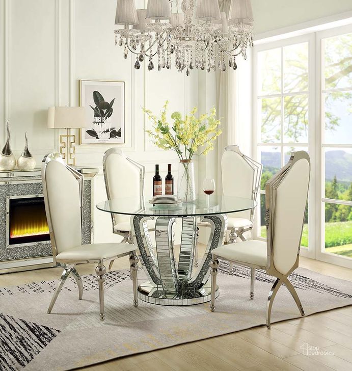 The appearance of Elandia Mirrored Dining Table 0qb24405923 designed by Sterling Designs in the glam interior design. This mirrored piece of furniture  was selected by 1StopBedrooms from Elandia Collection to add a touch of cosiness and style into your home. Sku: DN00717-1;DN00717-2. Table Base Style: Pedestal. Table Top Shape: Round. Material: Wood. Product Type: Dining Table. Size: 52". Image1
