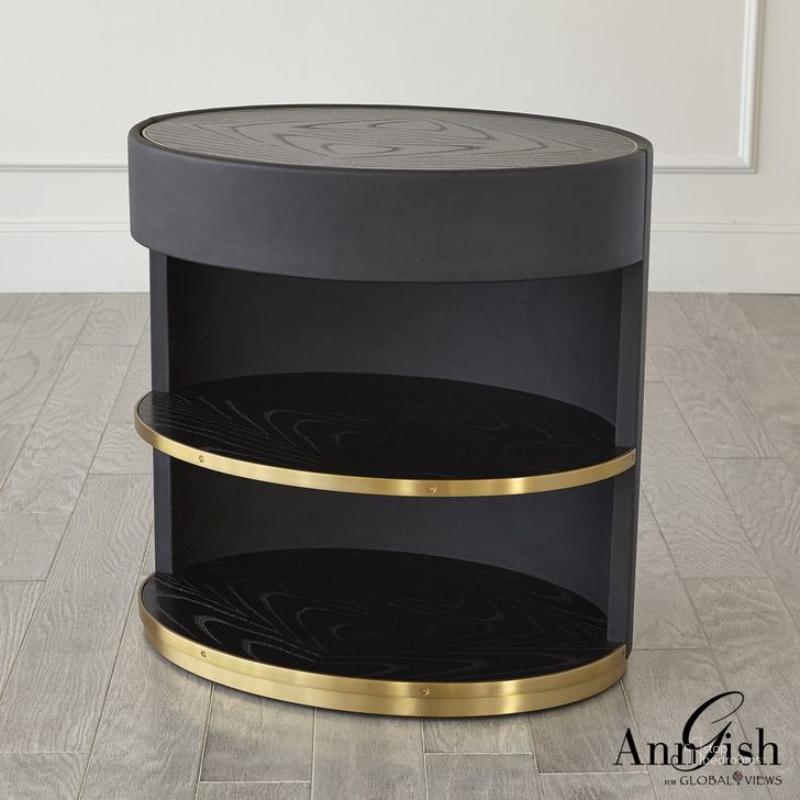 The appearance of Ellipse Bedside Cabinet In Black designed by Global Views in the modern / contemporary interior design. This black piece of furniture  was selected by 1StopBedrooms from Ellipse Collection to add a touch of cosiness and style into your home. Sku: AG2.20026. Product Type: Chest. Material: Brass. Image1