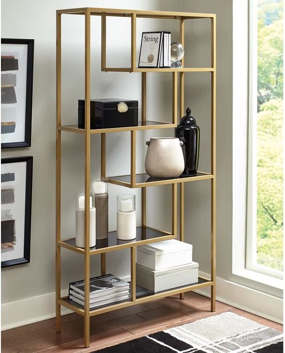 The appearance of Frankwell Gold Bookcase designed by Signature Design by Ashley in the transitional interior design. This gold piece of furniture  was selected by 1StopBedrooms from Frankwell Collection to add a touch of cosiness and style into your home. Sku: A4000286. Material: Glass. Product Type: Bookcase. Image1