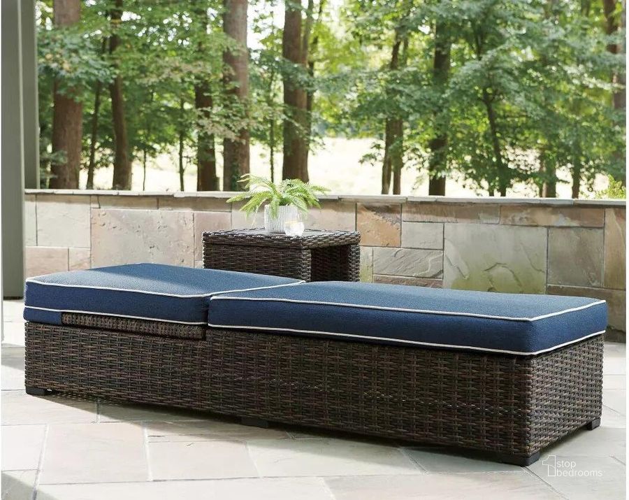The appearance of Grasson Lane Brown And Blue Outdoor Chaise Lounger With Cushion designed by Signature Design by Ashley in the transitional interior design. This brown/blue piece of furniture  was selected by 1StopBedrooms from Grasson Lane Collection to add a touch of cosiness and style into your home. Sku: P783-815. Material: Metal. Product Type: Outdoor Chaise Lounge. Image1