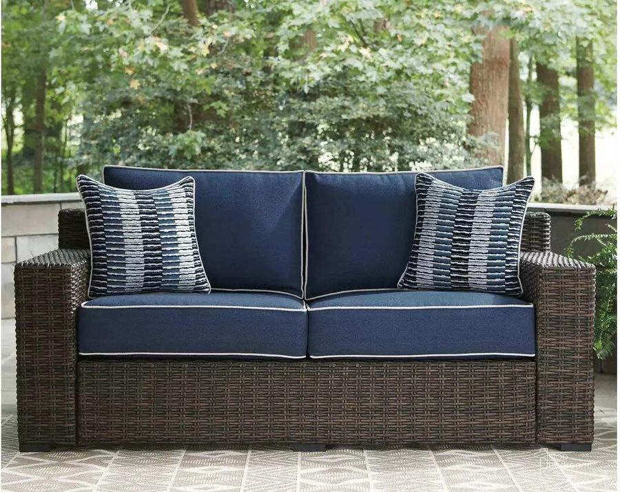 The appearance of Grasson Lane Brown And Blue Outdoor Loveseat With Cushion designed by Signature Design by Ashley in the transitional interior design. This brown/blue piece of furniture  was selected by 1StopBedrooms from Grasson Lane Collection to add a touch of cosiness and style into your home. Sku: P783-835. Material: Metal. Product Type: Outdoor Loveseat. Image1