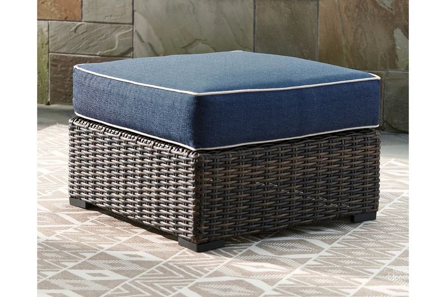 The appearance of Grasson Lane Brown And Blue Outdoor Ottoman With Cushion designed by Signature Design by Ashley in the transitional interior design. This brown/blue piece of furniture  was selected by 1StopBedrooms from Grasson Lane Collection to add a touch of cosiness and style into your home. Sku: P783-814. Material: Metal. Product Type: Outdoor Ottoman. Image1