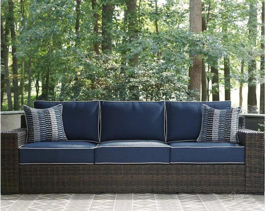 The appearance of Grasson Lane Brown And Blue Outdoor Sofa With Cushion designed by Signature Design by Ashley in the transitional interior design. This brown/blue piece of furniture  was selected by 1StopBedrooms from Grasson Lane Collection to add a touch of cosiness and style into your home. Sku: P783-838. Material: Metal. Product Type: Outdoor Sofa. Image1