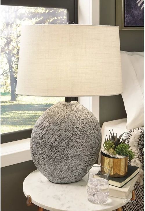 The appearance of Harif Beige Table Lamp designed by Signature Design by Ashley in the transitional interior design. This beige piece of furniture  was selected by 1StopBedrooms from Harif Collection to add a touch of cosiness and style into your home. Sku: L235624. Material: Other. Product Type: Table Lamp. Image1