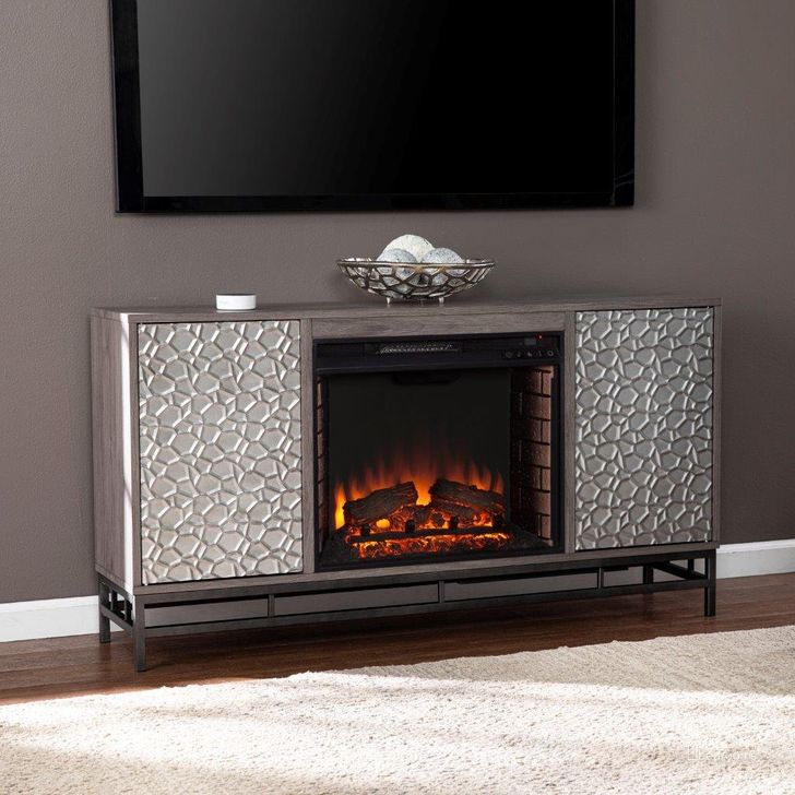 The appearance of Hollesborne Electric Fireplace With Media Storage designed by SEI Furniture in the modern / contemporary interior design. This grey piece of furniture  was selected by 1StopBedrooms from Hollesborne Collection to add a touch of cosiness and style into your home. Sku: FE1119656. Material: Wood. Product Type: Fireplace. Image1