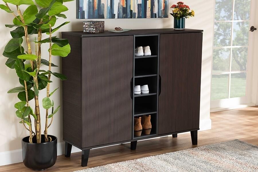 The appearance of Idina Mid-Century Modern Two-Tone Dark Brown and Grey Finished Wood 2-Door Shoe Cabinet designed by Baxton Studio in the transitional interior design. This dark brown piece of furniture  was selected by 1StopBedrooms from Idina Collection to add a touch of cosiness and style into your home. Sku: SESC16105-Modi Wenge-Shoe Cabinet. Material: Wood. Product Type: Shoe Cabinet. Image1
