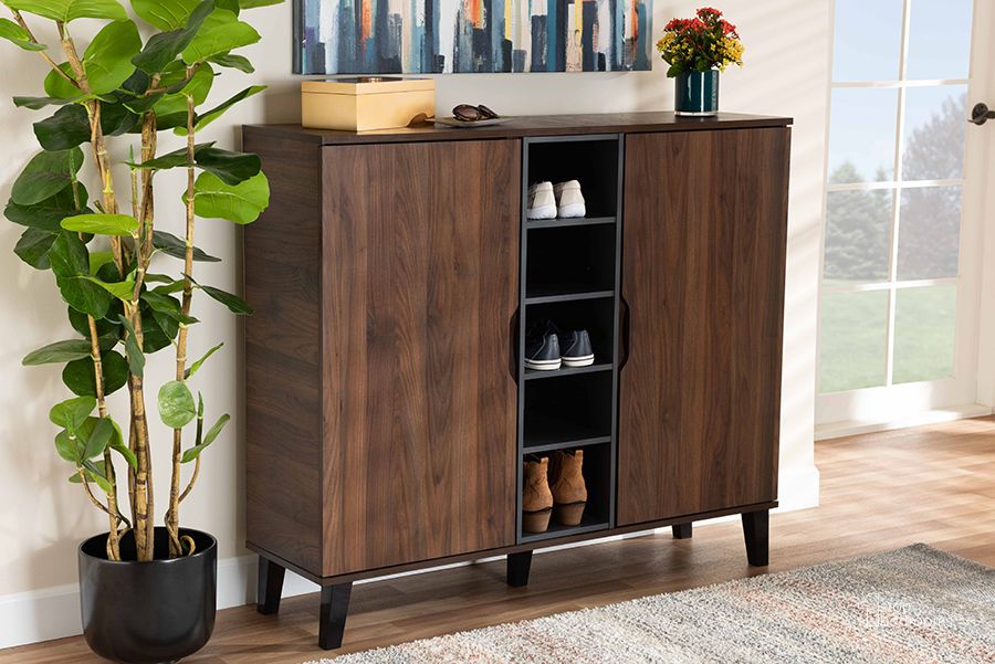 The appearance of Idina Mid-Century Modern Two-Tone Walnut Brown and Grey Finished Wood 2-Door Shoe Cabinet designed by Baxton Studio in the transitional interior design. This walnut piece of furniture  was selected by 1StopBedrooms from Idina Collection to add a touch of cosiness and style into your home. Sku: SESC16105-Columbia-Shoe Cabinet. Material: Wood. Product Type: Shoe Cabinet. Image1