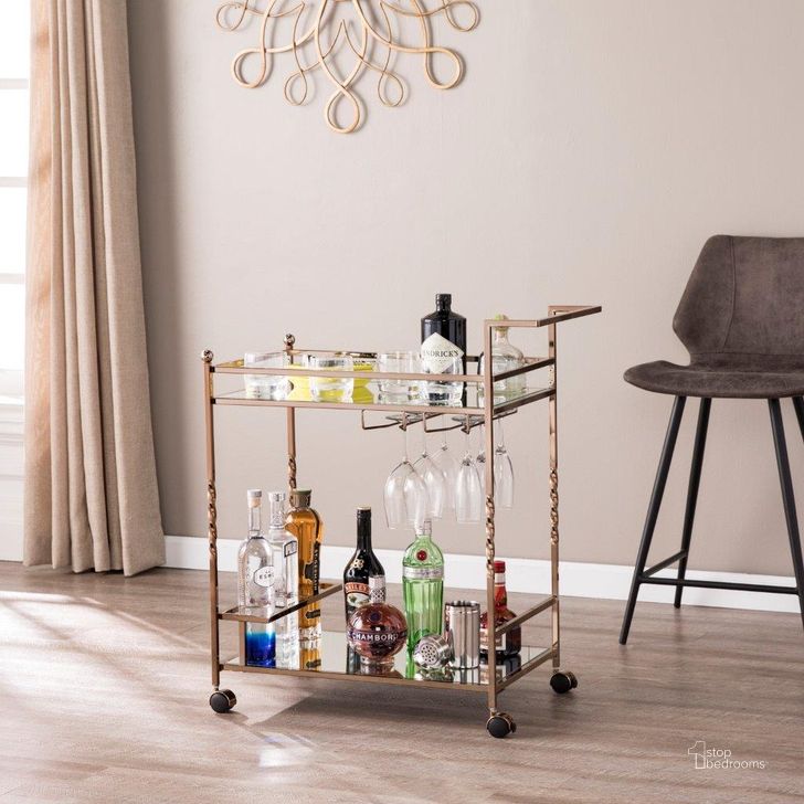The appearance of Ivers Metal Mirrored Bar Cart In Champagne designed by SEI Furniture in the glam interior design. This champagne piece of furniture  was selected by 1StopBedrooms from Ivers Collection to add a touch of cosiness and style into your home. Sku: HZ3585. Product Type: Bar Cart. Material: Iron. Image1