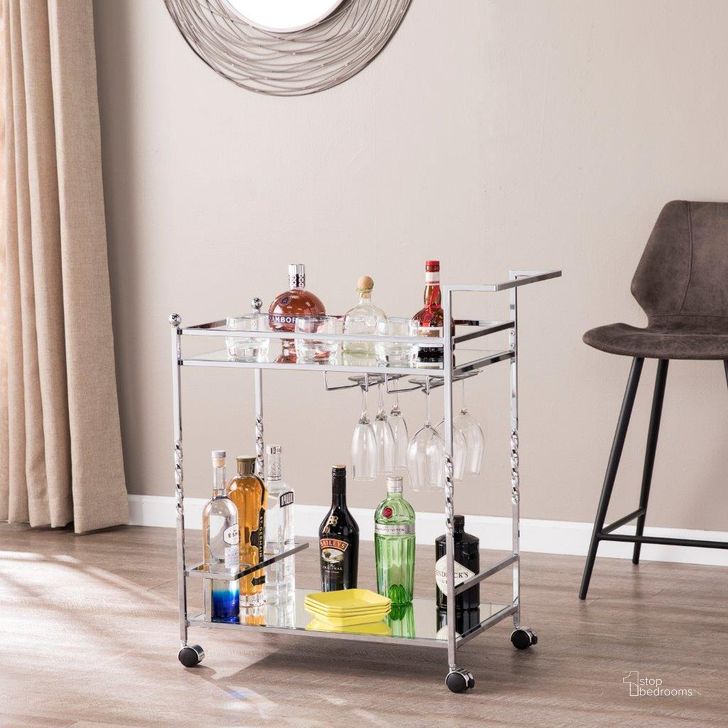 The appearance of Ivers Metal Mirrored Bar Cart In Chrome designed by SEI Furniture in the glam interior design. This chrome piece of furniture  was selected by 1StopBedrooms from Ivers Collection to add a touch of cosiness and style into your home. Sku: HZ3586. Product Type: Bar Cart. Material: Iron. Image1