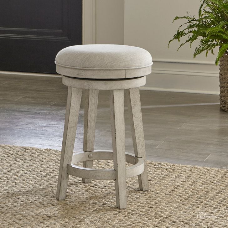 The appearance of Ivy Hollow Upholstered Swivel Stool In Weathered Linen With Dusty Taupe Top designed by Liberty in the country / farmhouse interior design. This taupe piece of furniture  was selected by 1StopBedrooms from Ivy Hollow Collection to add a touch of cosiness and style into your home. Sku: 457-OT9003. Product Type: Barstool. Material: Poplar. Image1
