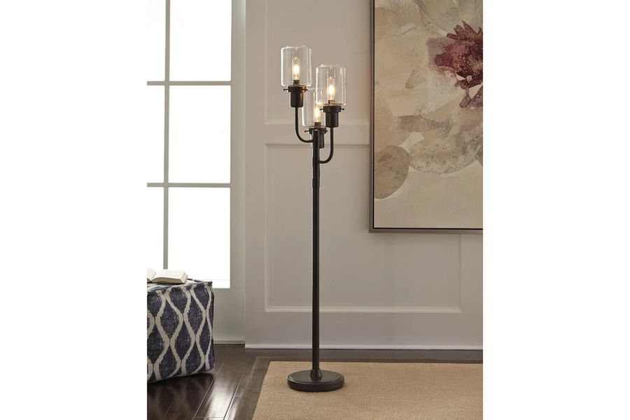 The appearance of Jaak Bronze Metal Floor Lamp designed by Signature Design by Ashley in the modern / contemporary interior design. This bronze piece of furniture  was selected by 1StopBedrooms from Jaak Collection to add a touch of cosiness and style into your home. Sku: L207171. Material: Glass. Product Type: Floor Lamp. Image1