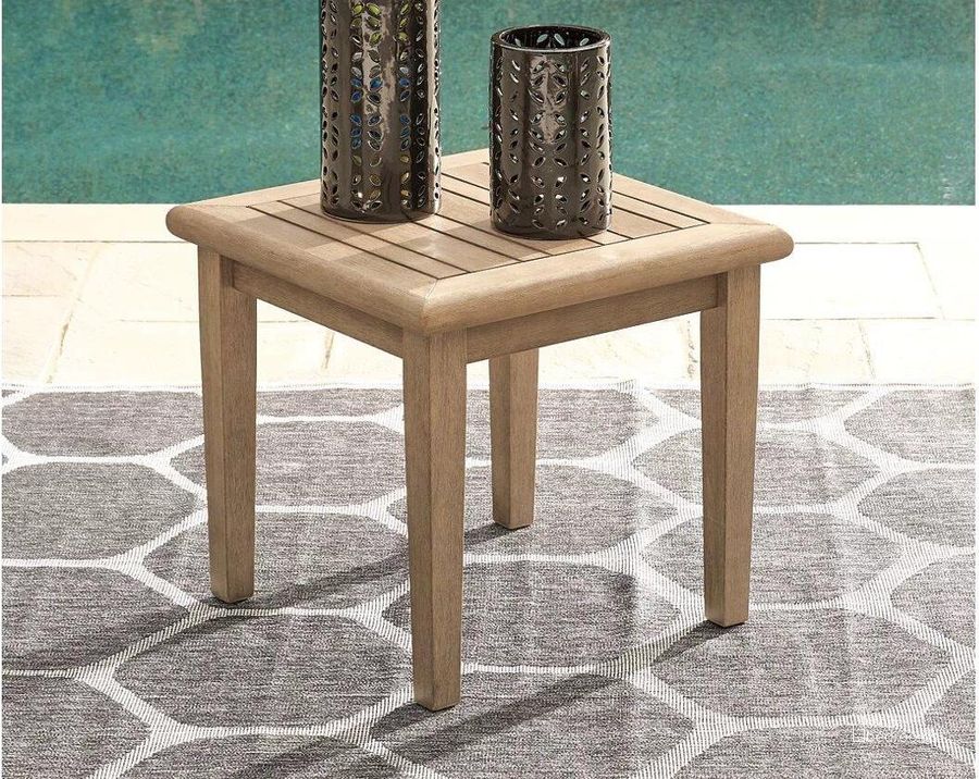 The appearance of Janway Lane Grayish Brown Outdoor Table 0qd24312727 designed by Isaac Tahari in the transitional interior design. This grayish brown piece of furniture  was selected by 1StopBedrooms from Janway Lane Collection to add a touch of cosiness and style into your home. Sku: P805-702. Material: Wood. Product Type: Outdoor Table. Image1