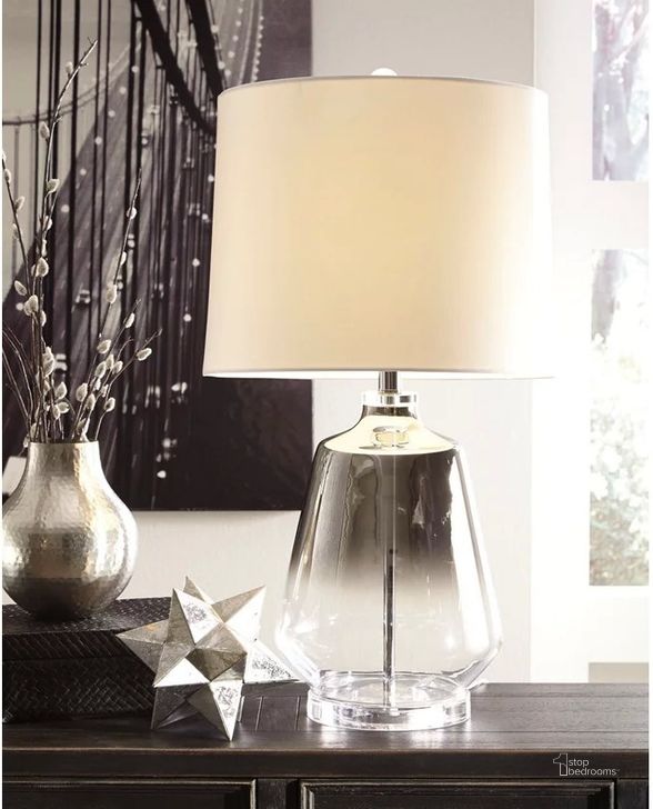 The appearance of Jaslyn Silver Glass Table Lamp designed by Signature Design by Ashley in the modern / contemporary interior design. This silver piece of furniture  was selected by 1StopBedrooms from Jaslyn Collection to add a touch of cosiness and style into your home. Sku: L430414. Material: Glass. Product Type: Table Lamp. Image1
