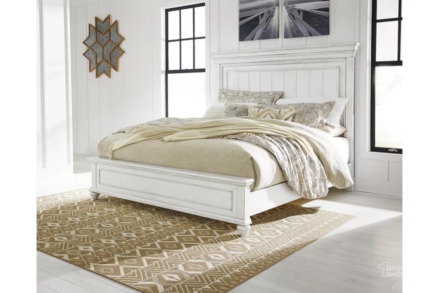 The appearance of Kanwyn California King Panel Bed In White Wash designed by Signature Design by Ashley in the transitional interior design. This white wash piece of furniture  was selected by 1StopBedrooms from Kanwyn Collection to add a touch of cosiness and style into your home. Sku: B777-56;B777-58;B777-94. Bed Type: Panel Bed. Material: Wood. Product Type: Panel Bed. Bed Size: California King. Image1