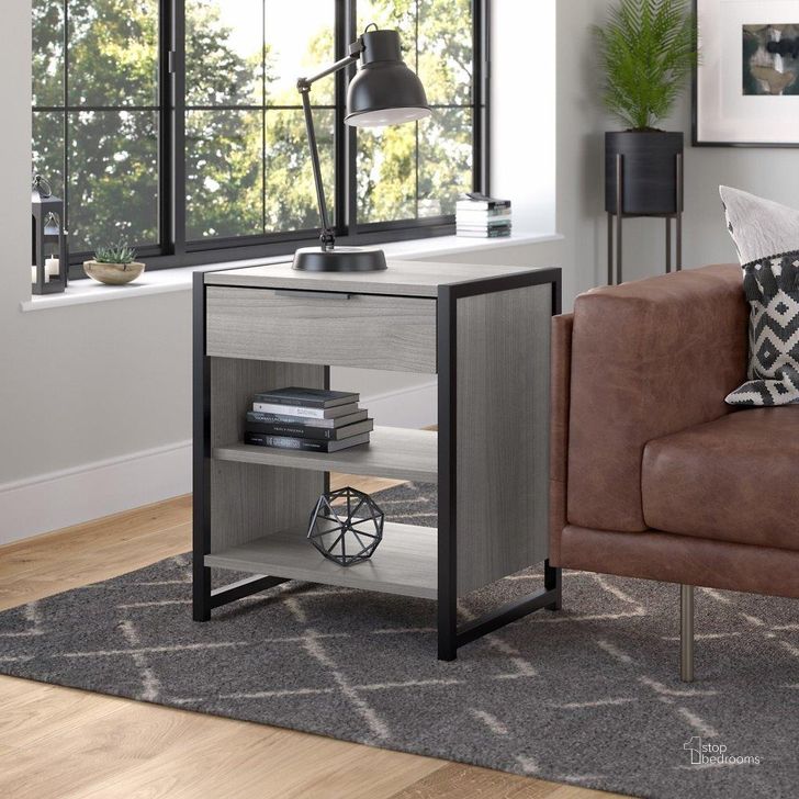 The appearance of Kathy Ireland Home by Bush Furniture Atria Small End Table with Drawer and Shelves in Platinum Gray designed by Bush Furniture in the industrial interior design. This gray piece of furniture  was selected by 1StopBedrooms from Atria Home Collection to add a touch of cosiness and style into your home. Sku: ARS119PG-Z. Material: Wood. Product Type: End Table. Image1