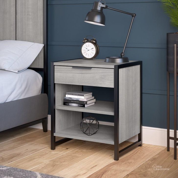 The appearance of Kathy Ireland Home By Bush Furniture Atria Small Nightstand With Drawer And Shelves In Platinum Gray designed by Bush Furniture in the industrial interior design. This gray piece of furniture  was selected by 1StopBedrooms from Atria Collection to add a touch of cosiness and style into your home. Sku: ARS119PG. Material: Wood. Product Type: Nightstand. Image1