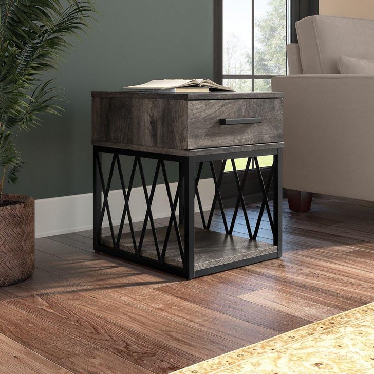 The appearance of Kathy Ireland Home By Bush Furniture City Park Industrial End Table With Drawer In Dark Gray Hickory designed by Bush Furniture in the industrial interior design. This dark gray piece of furniture  was selected by 1StopBedrooms from City Park Collection to add a touch of cosiness and style into your home. Sku: CPT118GH-03. Material: Wood. Product Type: End Table. Image1