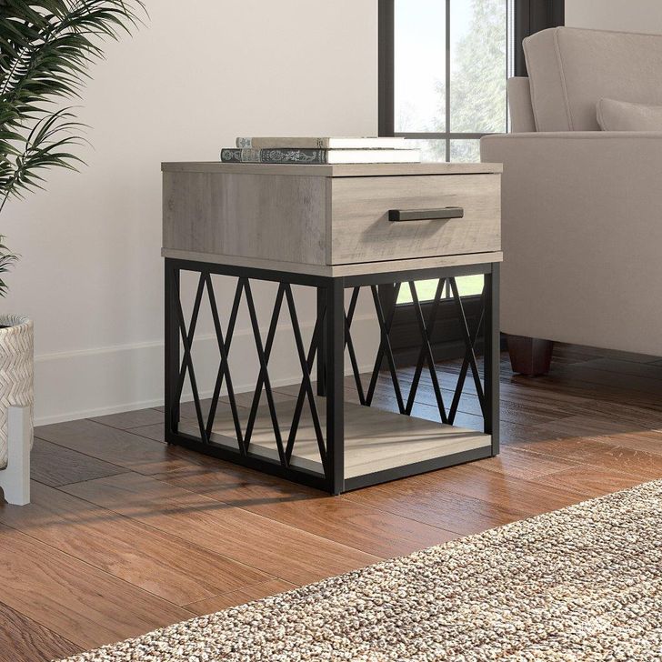 The appearance of Kathy Ireland Home By Bush Furniture City Park Industrial End Table With Drawer In Driftwood Gray designed by Bush Furniture in the industrial interior design. This gray piece of furniture  was selected by 1StopBedrooms from City Park Collection to add a touch of cosiness and style into your home. Sku: CPT118DG-03. Material: Wood. Product Type: End Table. Image1