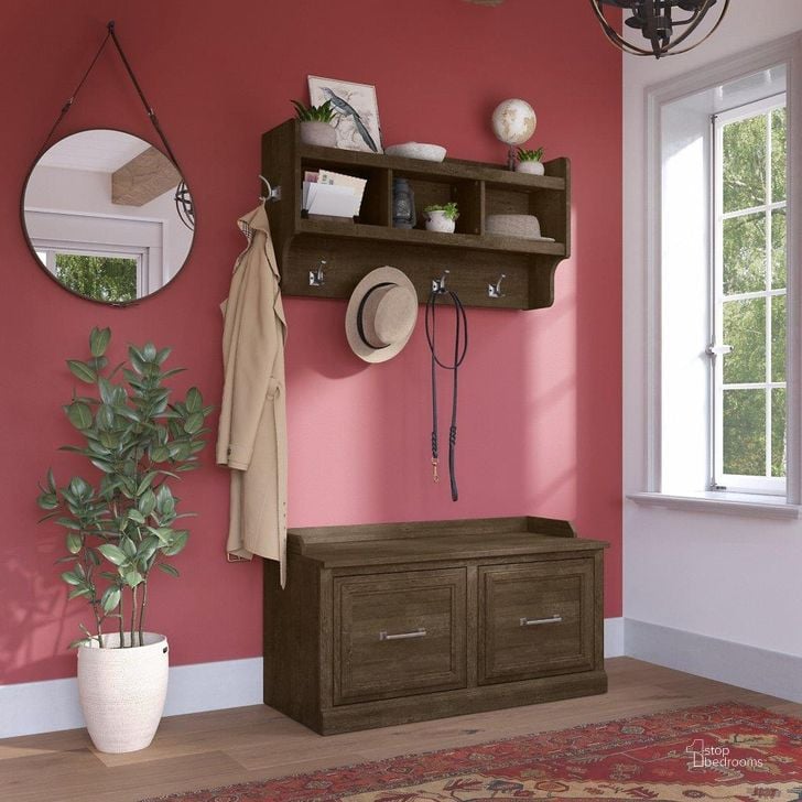 The appearance of Kathy Ireland Home by Bush Furniture Woodland 40W Shoe Storage Bench with Doors and Wall Mounted Coat Rack in Ash Brown designed by Bush Furniture in the traditional interior design. This brown piece of furniture  was selected by 1StopBedrooms from Woodland Collection to add a touch of cosiness and style into your home. Sku: WDL003ABR. Product Type: Shoe Cabinet. Image1