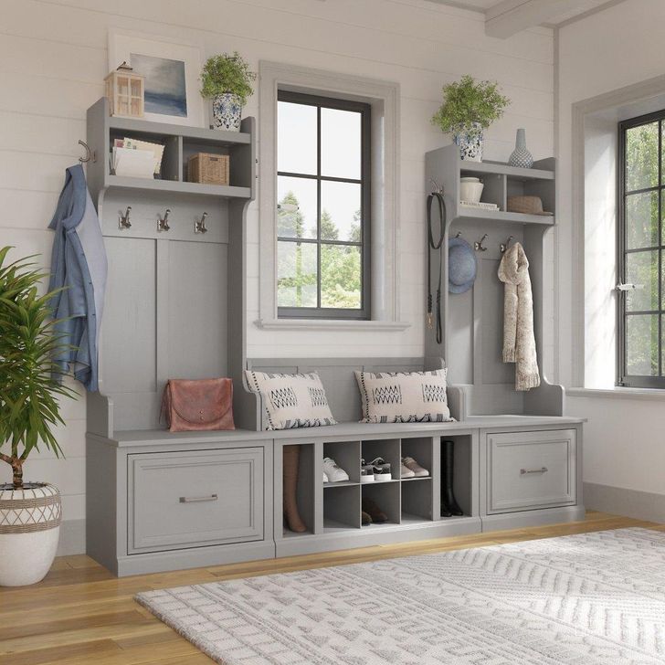 The appearance of Kathy Ireland Home by Bush Furniture Woodland Entryway Storage Set with Hall Trees and Shoe Bench with Drawers in Cape Cod Gray designed by Bush Furniture in the traditional interior design. This gray piece of furniture  was selected by 1StopBedrooms from Woodland Collection to add a touch of cosiness and style into your home. Sku: WDL012CG. Product Type: Entryway Furniture. Image1
