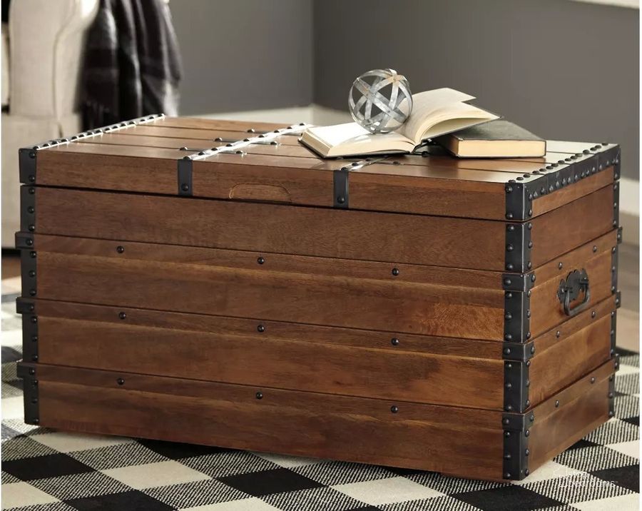 The appearance of Kettleby Brown Storage Trunk designed by Signature Design by Ashley in the transitional interior design. This brown piece of furniture  was selected by 1StopBedrooms from Kettleby Collection to add a touch of cosiness and style into your home. Sku: A4000096. Material: Metal. Product Type: Storage Trunk. Image1