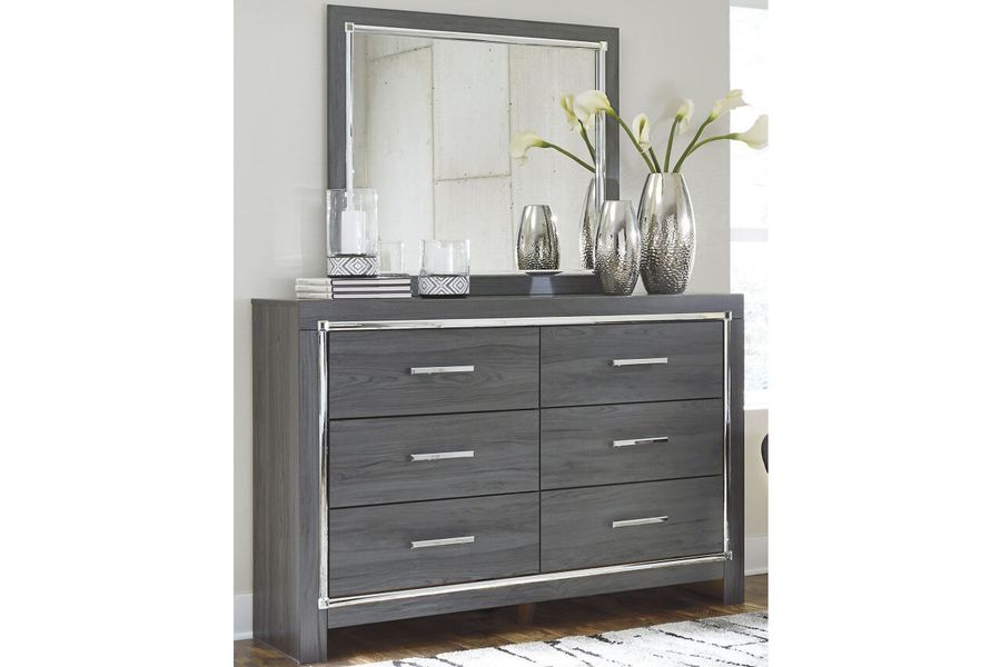 The appearance of Lodanna Dresser and Mirror In Gray designed by Signature Design by Ashley in the modern / contemporary interior design. This gray piece of furniture  was selected by 1StopBedrooms from Lodanna Collection to add a touch of cosiness and style into your home. Sku: B214-31;B214-36. Material: Wood. Product Type: Dresser and Mirror. Image1