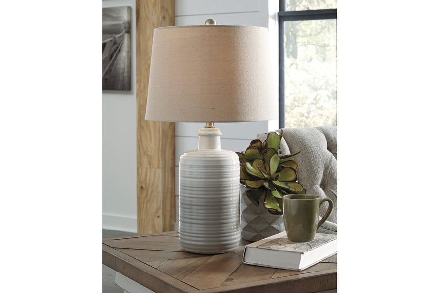 The appearance of Marnina Brown Ceramic Table Lamp Set of 2 designed by Signature Design by Ashley in the transitional interior design. This taupe piece of furniture  was selected by 1StopBedrooms from Marnina Collection to add a touch of cosiness and style into your home. Sku: L121854. Material: Stone. Product Type: Table Lamp. Image1