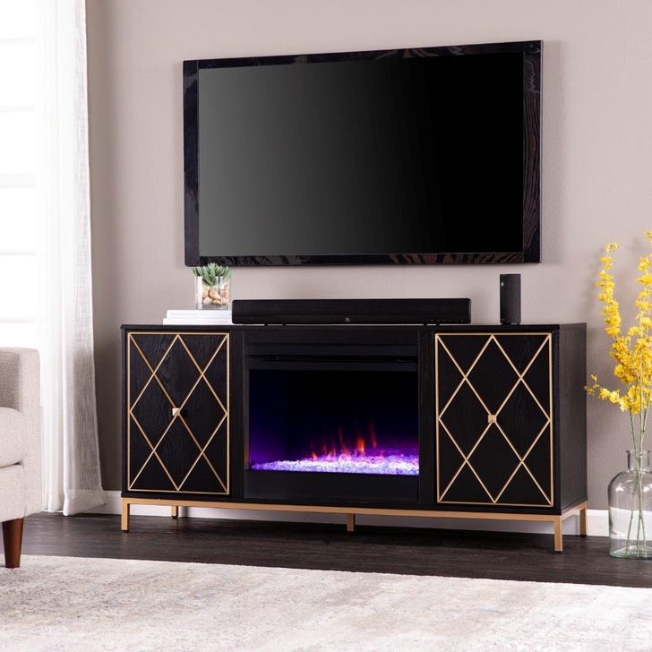 The appearance of Marradi Color Changing Fireplace With Media Storage designed by SEI Furniture in the modern / contemporary interior design. This black and gold piece of furniture  was selected by 1StopBedrooms from Marradi Collection to add a touch of cosiness and style into your home. Sku: FC1111956. Material: Wood. Product Type: Fireplace. Image1