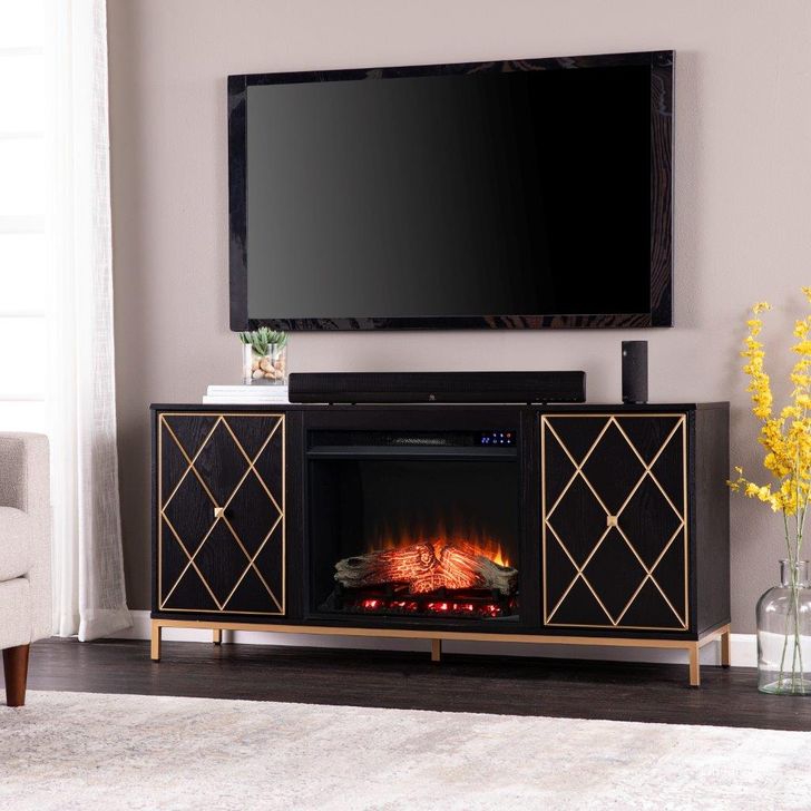 The appearance of Marradi Touch Screen Electric Fireplace With Media Storage designed by SEI Furniture in the modern / contemporary interior design. This black and gold piece of furniture  was selected by 1StopBedrooms from Marradi Collection to add a touch of cosiness and style into your home. Sku: FR1111956. Material: Wood. Product Type: Fireplace. Image1