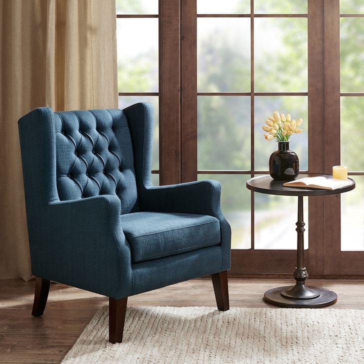 The appearance of Maxwell Button Tufted Wing Chair In Navy designed by Olliix in the transitional interior design. This navy piece of furniture  was selected by 1StopBedrooms from Maxwell Collection to add a touch of cosiness and style into your home. Sku: MP100-0017. Material: Wood. Product Type: Accent Chair. Image1