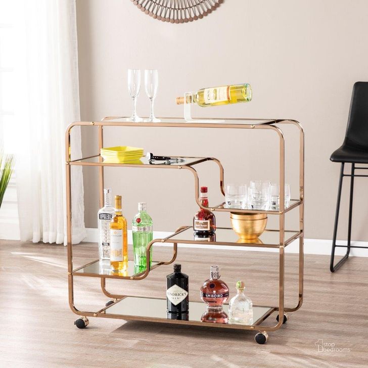 The appearance of Maylynn Art Deco Mirrored Bar Cart designed by SEI Furniture in the transitional interior design. This champagne piece of furniture  was selected by 1StopBedrooms from Maylynn Collection to add a touch of cosiness and style into your home. Sku: HZ2056. Product Type: Bar Cart. Material: Iron. Image1