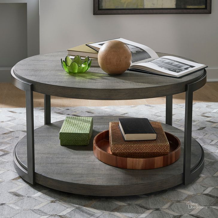 The appearance of Modern View Round Cocktail Table In Gauntlet Gray designed by Liberty in the modern / contemporary interior design. This gray piece of furniture  was selected by 1StopBedrooms from Modern View Collection to add a touch of cosiness and style into your home. Sku: 960-OT1010T;960-OT1010B. Product Type: Cocktail Table. Material: Wood Veneer. Image1