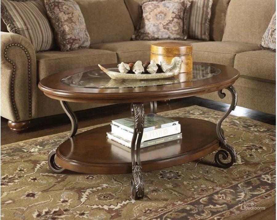 The appearance of Nestor Oval Cocktail Table designed by Signature Design by Ashley in the traditional interior design. This medium brown piece of furniture  was selected by 1StopBedrooms from Nestor Collection to add a touch of cosiness and style into your home. Sku: T517-0. Table Top Shape: Oval. Material: Glass. Product Type: Cocktail Table. Image1