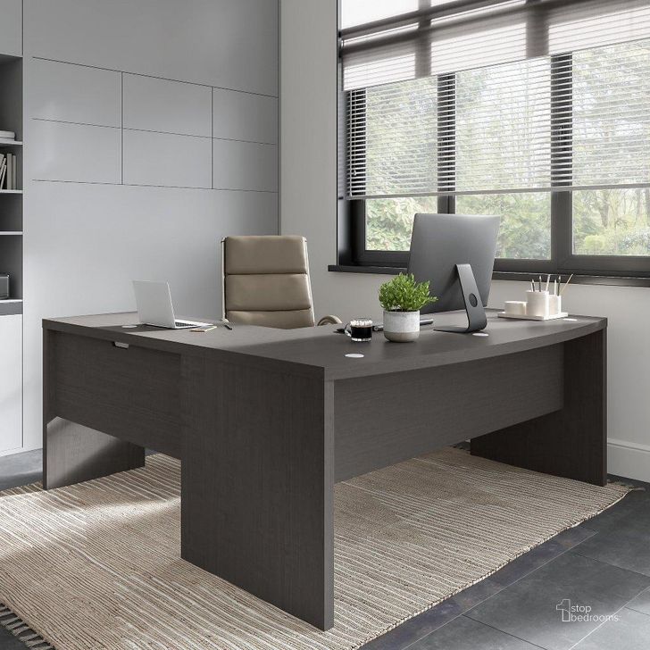 The appearance of Office By Kathy Ireland Echo 72W Bow Front L Shaped Desk In Charcoal Maple designed by Bush Furniture in the modern / contemporary interior design. This charcoal piece of furniture  was selected by 1StopBedrooms from Echo Collection to add a touch of cosiness and style into your home. Sku: ECH053CM. Material: Wood. Product Type: Home Office Desk. Image1