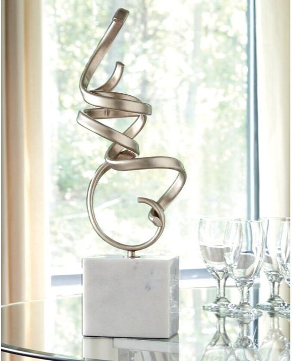 The appearance of Pallaton White Sculpture designed by Signature Design by Ashley in the transitional interior design. This champagne/white piece of furniture  was selected by 1StopBedrooms from Pallaton Collection to add a touch of cosiness and style into your home. Sku: A2000125. Material: Marble. Product Type: Sculpture. Image1