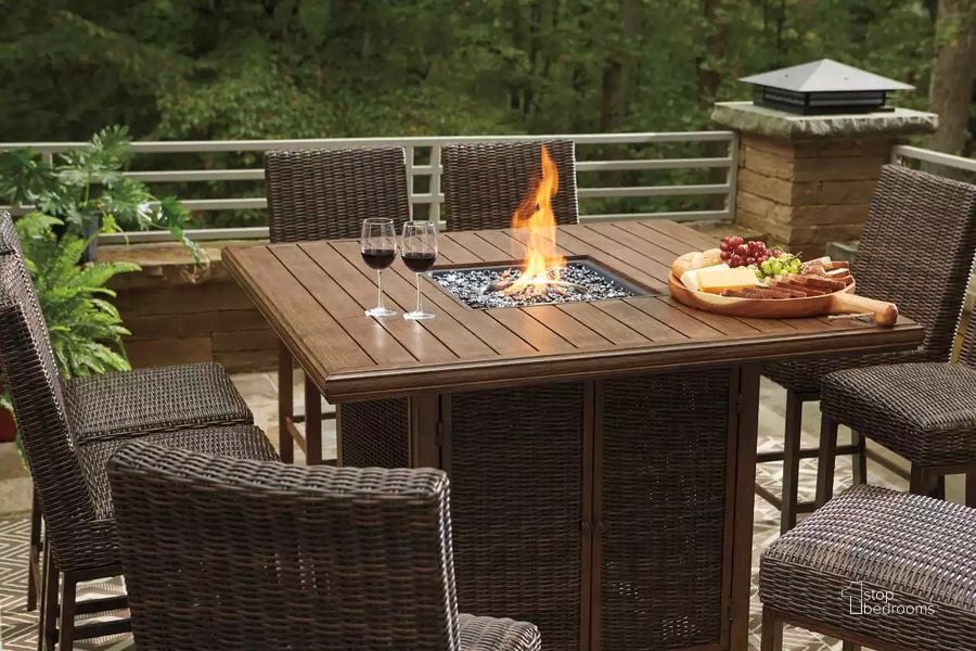 The appearance of Paradise Trail Medium Brown Outdoor Square Bar Table with Fire Pit designed by Signature Design by Ashley in the modern / contemporary interior design. This medium brown piece of furniture  was selected by 1StopBedrooms from Paradise Trail Collection to add a touch of cosiness and style into your home. Sku: P750-665. Material: Wood. Product Type: Outdoor Dining Table. Image1