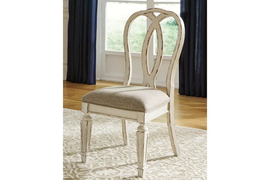 The appearance of Realyn White Dining Upholstered Sidechair Set of 2 designed by Signature Design by Ashley in the transitional interior design. This chipped white piece of furniture  was selected by 1StopBedrooms from Realyn Collection to add a touch of cosiness and style into your home. Sku: D743-02. Material: Fabric. Product Type: Side Chair. Image1