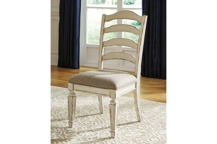 The appearance of Realyn White Dining Upholstered Slatback Side Chair Set of 2 designed by Signature Design by Ashley in the transitional interior design. This chipped white piece of furniture  was selected by 1StopBedrooms from Realyn Collection to add a touch of cosiness and style into your home. Sku: D743-01. Material: Fabric. Product Type: Side Chair. Image1