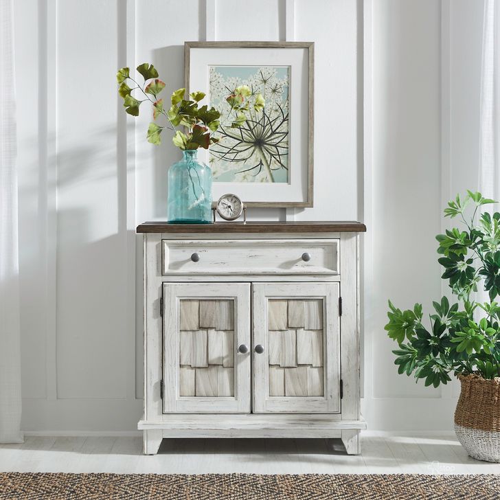 The appearance of River Place Accent Cabinet In Riverstone White and Tobacco designed by Liberty in the country / farmhouse interior design. This white piece of furniture  was selected by 1StopBedrooms from River Place Collection to add a touch of cosiness and style into your home. Sku: 237-AC1000. Product Type: Cabinet. Material: Wood Veneer. Image1