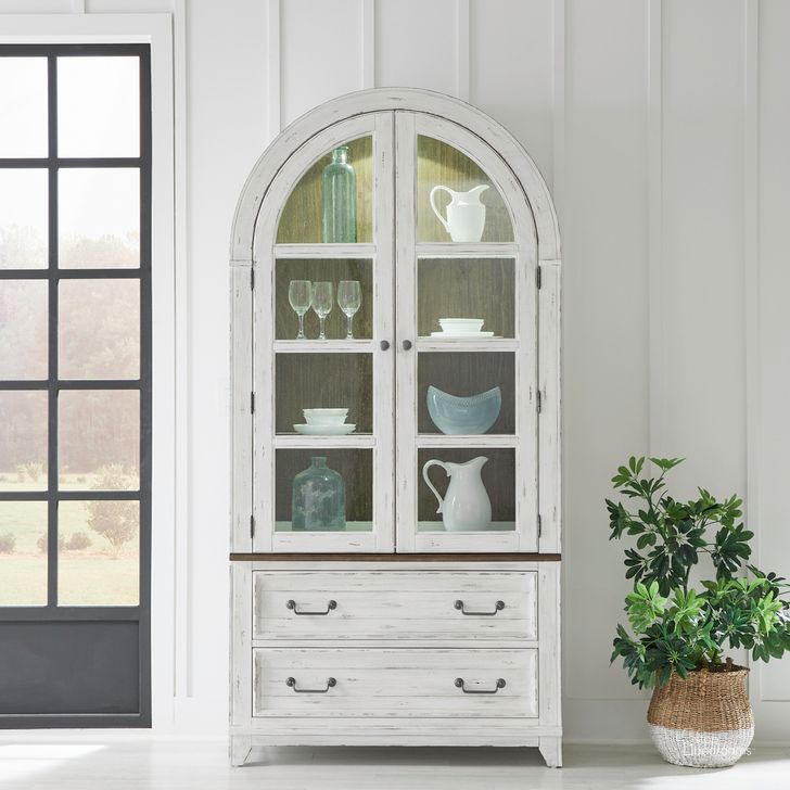The appearance of River Place Curio Cabinet In Riverstone White and Tobacco designed by Liberty in the country / farmhouse interior design. This white piece of furniture  was selected by 1StopBedrooms from River Place Collection to add a touch of cosiness and style into your home. Sku: 237-CB4490;237-CH4490. Product Type: Curio. Material: Wood Veneer. Image1